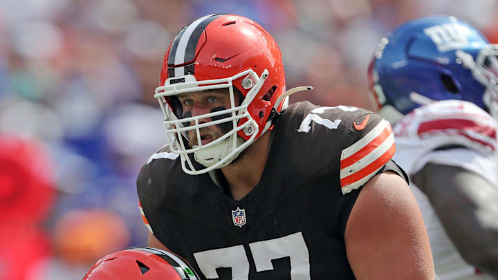 Cleveland Browns guard Wyatt Teller (77) helps up quarterback Deshaun Watson (4) during the first half of an NFL football game against the New York Giants at Huntington Bank Field, Sunday, Sept. 22, 2024, in Cleveland, Ohio.