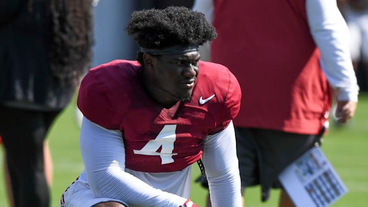 The Crimson Tide players and coaches continue working toward the season opener in practice Tuesday, Aug. 13, 2024. Alabama linebacker Qua Russaw (4) takes a break during the practice.