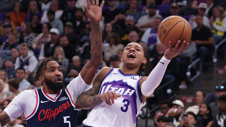 Oct 22, 2025; Salt Lake City, Utah, USA; Utah Jazz guard Keyonte George (3) drives against Los Angeles Clippers forward Derrick Jones Jr. (5) during the second quarter at Delta Center. Mandatory Credit: Rob Gray-Imagn Images