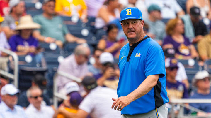 Jun 16, 2025; Omaha, Neb, USA; UCLA Bruins head coach John Savage walks off the field before the game against the LSU Tigers at Charles Schwab Field. Mandatory Credit: Dylan Widger-Imagn Images