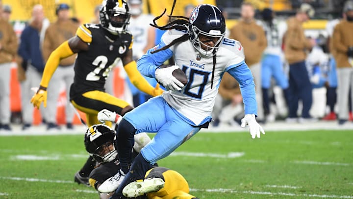 Nov 2, 2023; Pittsburgh, Pennsylvania, USA; Tennessee Titans wide receiver DeAndre Hopkins (10) is tripped up by Pittsburgh Steelers linebacker Kwon Alexander (54) during the second quarter at Acrisure Stadium. Mandatory Credit: Philip G. Pavely-Imagn Images