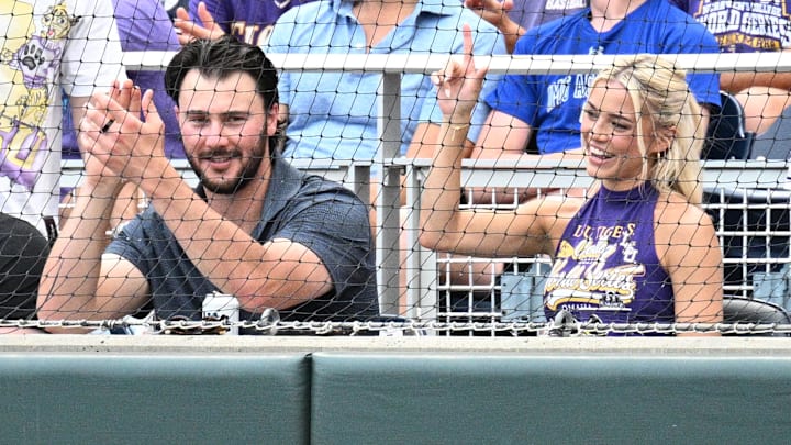 LSU Tiger alumni Paul Skenes and Livvy Dunne watch action against the UCLA Bruinsat Charles Schwab Field.