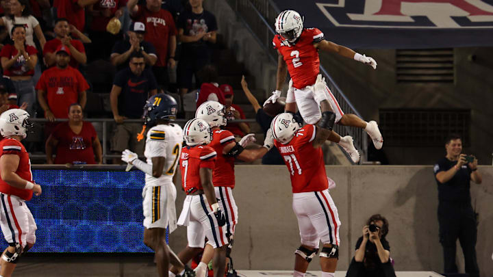 Sep 7, 2024; Tucson, Arizona, USA; Arizona Wildcats wide receiver Jeremiah Patterson (2) celebrates a touchdown with Arizona Wildcats offensive lineman Jonah Savaiinaea (71) during the third quarter against Northern Arizona Lumberjacks at Arizona Stadium. Sep 7, 2024; Tucson, Arizona, USA; Arizona Wildcats wide receiver Jeremiah Patterson (2) celebrates a touchdown with Arizona Wildcats offensive lineman Jonah Savaiinaea (71) during the third quarter against Northern Arizona Lumberjacks at Arizona Stadium.