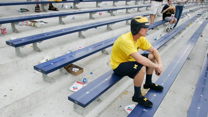 A Michigan fan sits in disbelief after the loss to Oregon in the Big House in 2007.
