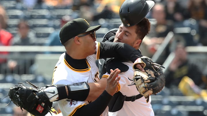 Apr 9, 2025; Pittsburgh, Pennsylvania, USA;  Pittsburgh Pirates first baseman Endy Rodriguez (5) and catcher Joey Bart (14) collide attempting to catch a pop-up hit by St. Louis Cardinals designated hitter Willson Contreras (not pictured) during the eighth inning at PNC Park. Mandatory Credit: Charles LeClaire-Imagn Images
