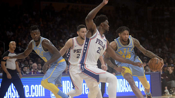 November 15, 2017; Los Angeles, CA, USA; Los Angeles Lakers forward Brandon Ingram (14) moves the ball against Philadelphia 76ers center Joel Embiid (21) as guard Ben Simmons (25) provides coverage against forward Julius Randle (30) during the second half at Staples Center. Mandatory Credit: Gary A. Vasquez-Imagn Images