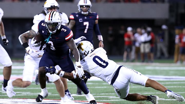 Sep 2, 2023; Tucson, Arizona, USA; Arizona Wildcats running back Jonah Coleman (3) sheds a tackle agaisnt Northern Arizona Lumberjacks running back Chase Belcher (0) during the second half at Arizona Stadium. Mandatory Credit: Zac BonDurant-USA TODAY Sports