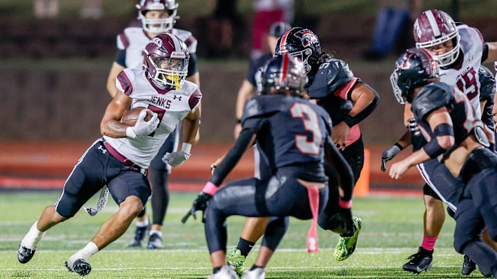 Jenks’ Kaydin Jones (2) runs the ball during a high school football game between Mustang and Jenks in Mustang, Okla., on Friday, Oct. 11, 2024.
