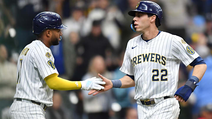 Apr 20, 2025; Milwaukee, Wisconsin, USA; Milwaukee Brewers left fielder Christian Yelich (22) and right fielder Jackson Chourio (11) celebrate after scoring during the seventh inning against the Athletics at American Family Field. Mandatory Credit: Patrick Gorski-Imagn Images