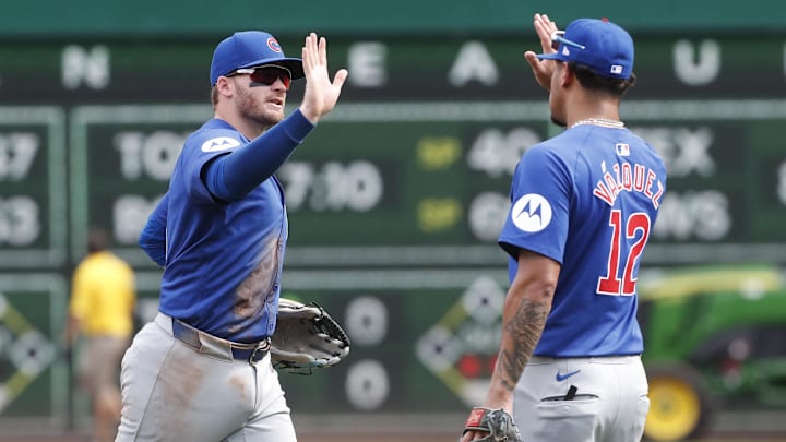 Aug 28, 2024; Pittsburgh, Pennsylvania, USA;  Chicago Cubs left fielder Ian Happ (8) and second baseman  Luis Vazquez (12) celebrate after defeating the Pittsburgh Pirates at PNC Park. Chicago won 14-10.
