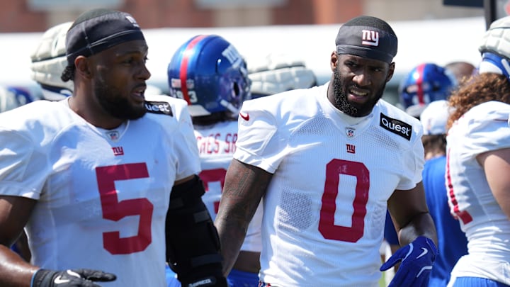 Jul 26, 2024; East Rutherford, NJ, USA; New York Giants linebacker Kayvon Thibodeaux (5) and New York Giants linebacker Brian Burns (0) break on the sideline during training camp at Quest Diagnostics Training Center. 