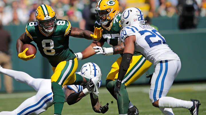 Green Bay Packers running back Josh Jacobs (8) runs for a first down against Indianapolis Colts safety Nick Cross (20) during their football game Sunday, September 15, 2024, at Lambeau Field in Green Bay, Wisconsin.