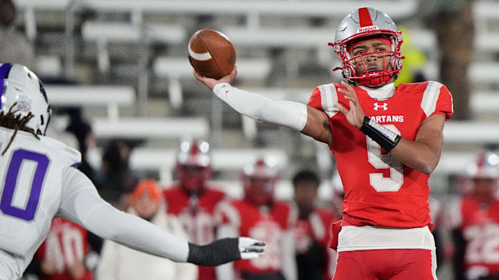 Dec 6, 2024; Birmingham, AL, USA; Saraland's KJ Lacey (9) throws a pass as he is pressured by a Parker defender at Protective Stadium in the 6A State Championship game. Parker defeated Saraland 28-17.
