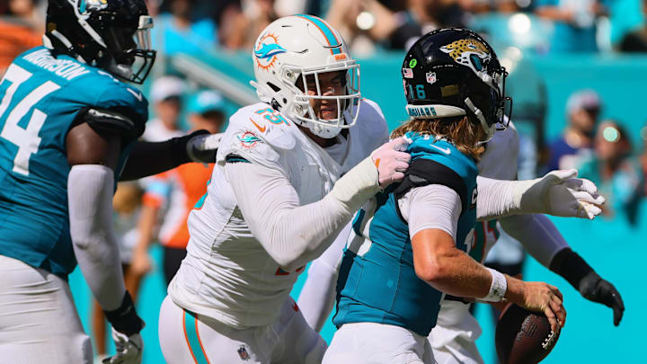 Sep 8, 2024; Miami Gardens, Florida, USA; Miami Dolphins linebacker Jaelan Phillips (15) sacks Jacksonville Jaguars quarterback Trevor Lawrence (16) during the fourth quarter at Hard Rock Stadium. Mandatory Credit: Sam Navarro-Imagn Images Sep 8, 2024; Miami Gardens, Florida, USA; Miami Dolphins linebacker Jaelan Phillips (15) sacks Jacksonville Jaguars quarterback Trevor Lawrence (16) during the fourth quarter at Hard Rock Stadium. Mandatory Credit: Sam Navarro-Imagn Images