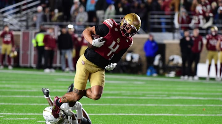Nov 15, 2025; Chestnut Hill, Massachusetts, USA; Boston College Eagles wide receiver Reed Harris (4) breaks a tackle from a Georgia Tech Yellow Jackets defender and scores a touchdown during the second half at Alumni Stadium. Mandatory Credit: Bob DeChiara-Imagn Images Nov 15, 2025; Chestnut Hill, Massachusetts, USA; Boston College Eagles wide receiver Reed Harris (4) breaks a tackle from a Georgia Tech Yellow Jackets defender and scores a touchdown during the second half at Alumni Stadium. Mandatory Credit: Bob DeChiara-Imagn Images
