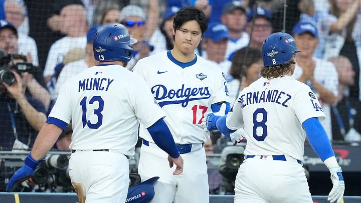 Oct 28, 2025; Los Angeles, California, USA; Los Angeles Dodgers first baseman Enrique Hernandez (8) celebrates with two-way player Shohei Ohtani (17) after hitting an RBI sacrifice fly to score third baseman Max Muncy (13) in the second inning against the Toronto Blue Jays during game four of the 2025 MLB World Series at Dodger Stadium. Mandatory Credit: Kirby Lee-Imagn Images