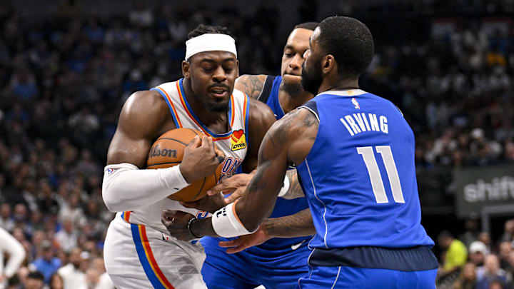 Jan 17, 2025; Dallas, Texas, USA; Oklahoma City Thunder guard Luguentz Dort (5) takes the ball away from Dallas Mavericks forward P.J. Washington (25) as guard Kyrie Irving (11) looks on during the second quarter at the American Airlines Center. Mandatory Credit: Jerome Miron-Imagn Images Jan 17, 2025; Dallas, Texas, USA; Oklahoma City Thunder guard Luguentz Dort (5) takes the ball away from Dallas Mavericks forward P.J. Washington (25) as guard Kyrie Irving (11) looks on during the second quarter at the American Airlines Center. Mandatory Credit: Jerome Miron-Imagn Images