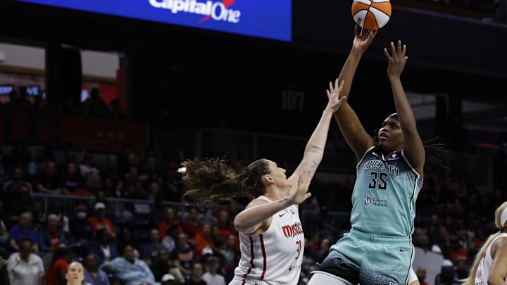 May 30, 2025; Washington, District of Columbia, USA; New York Liberty center Jonquel Jones (35) shoots the ball over Washington Mystics center Stefanie Dolson (31) in the first half at CareFirst Arena. Mandatory Credit: Geoff Burke-Imagn Images