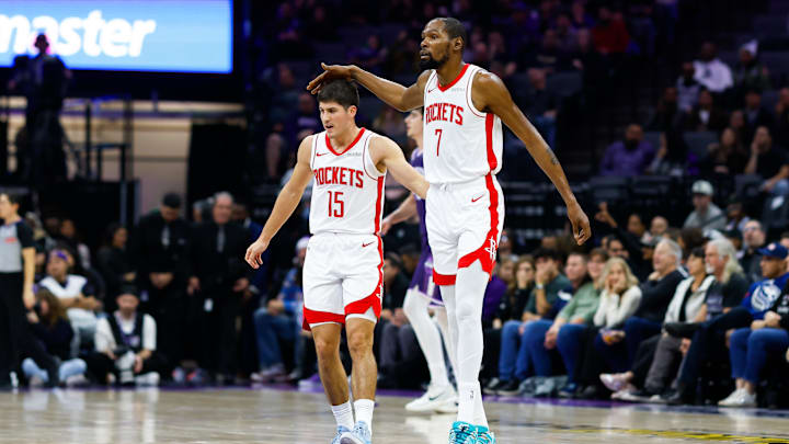 Dec 21, 2025; Sacramento, California, USA; Houston Rockets forward Kevin Durant (7) pats guard Reed Sheppard (15) during the second quarter against the Sacramento Kings at Golden 1 Center. Mandatory Credit: Sergio Estrada-Imagn Images