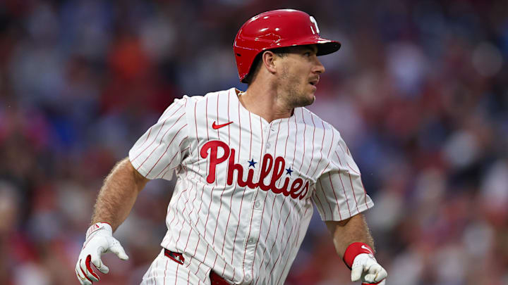 Sep 10, 2025; Philadelphia, Pennsylvania, USA; Philadelphia Phillies catcher J.T. Realmuto (10) hits an RBI single against the New York Mets during the first inning at Citizens Bank Park.