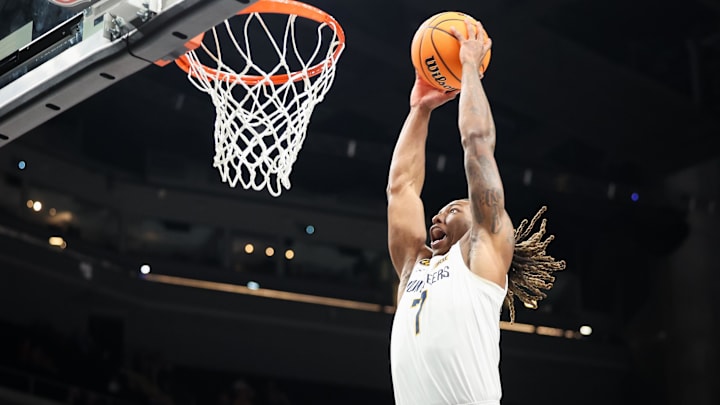 Mar 12, 2025; Kansas City, MO, USA; West Virginia Mountaineers guard Javon Small (7) dunks during the first half against the Colorado Buffaloes at T-Mobile Center. Mandatory Credit: William Purnell-Imagn Images