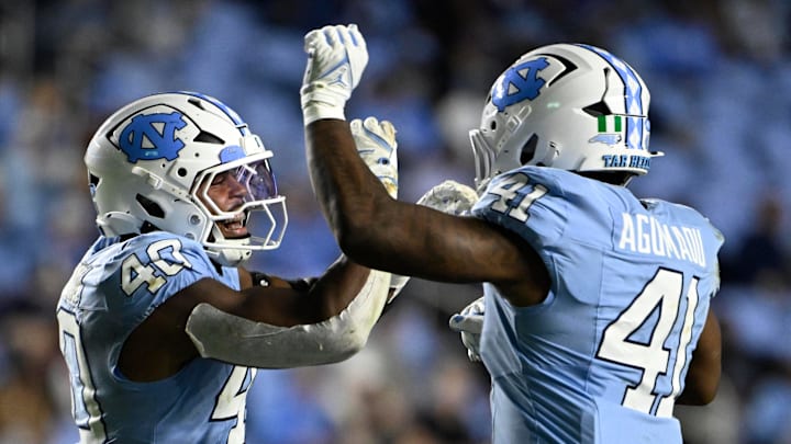 Nov 8, 2025; Chapel Hill, North Carolina, USA;  North Carolina Tar Heels linebacker Tyler Thompson (40) reacts with linebacker Jonathan Agumadu (41) after a sack in the fourth quarter at Kenan Stadium. Mandatory Credit: Bob Donnan-Imagn Images