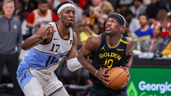 Mar 22, 2025; Atlanta, Georgia, USA; Golden State Warriors forward Jimmy Butler III (10) drives on Atlanta Hawks forward Onyeka Okongwu (17) in the third quarter at State Farm Arena. Mandatory Credit: Brett Davis-Imagn Images