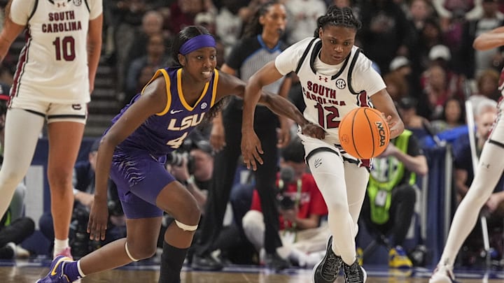 Mar 10, 2024; Greensville, SC, USA; South Carolina Gamecocks guard MiLaysia Fulwiley (12) steals the ball from LSU Lady Tigers guard Flau'jae Johnson (4) during the second half at Bon Secours Wellness Arena. Mandatory Credit: Jim Dedmon-Imagn Images Mar 10, 2024; Greensville, SC, USA; South Carolina Gamecocks guard MiLaysia Fulwiley (12) steals the ball from LSU Lady Tigers guard Flau'jae Johnson (4) during the second half at Bon Secours Wellness Arena. Mandatory Credit: Jim Dedmon-Imagn Images