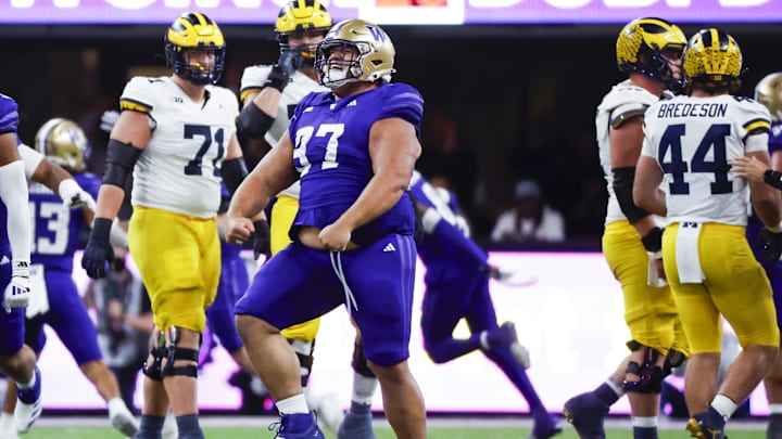 Oct 5, 2024; Seattle, Washington, USA; Washington Huskies defensive lineman Logan Sagapolu (97) celebrates after recovering a fumble against the Michigan Wolverines during the fourth quarter at Alaska Airlines Field at Husky Stadium. Mandatory Credit: Joe Nicholson-Imagn Images