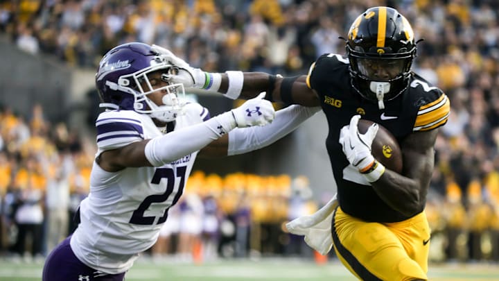 Iowa’s Kaleb Johnson (2) stiff arms Northwestern’s Jack Oyola (27) enroute to scoring a touchdown in the second quarter Saturday, Oct. 26, 2024 at Kinnick Stadium in Iowa City, Iowa.