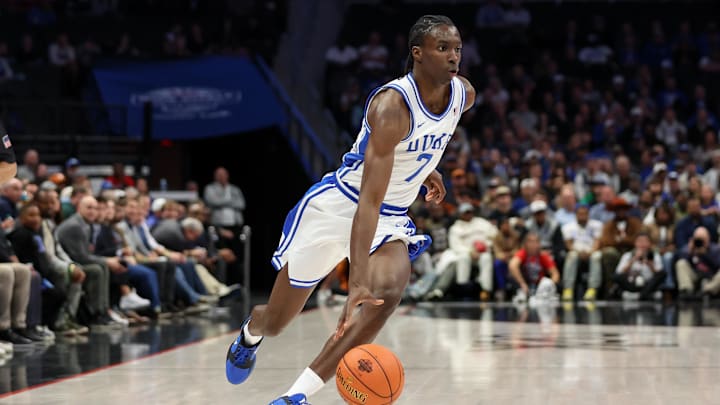 Nov 4, 2025; Charlotte, North Carolina, USA; Duke Blue Devils guard Dame Sarr (7) drives the ball against the Texas Longhorns during the first half of Dick Vitale’s Invitational game at Spectrum Center.
