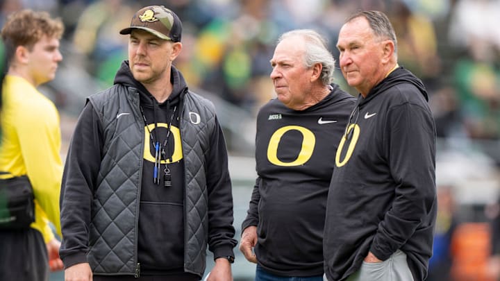 Oregon offensive coordinator Will Stein, left, former Oregon defensive coordinator Nick Aliotti and former Oregon coach Rich Brooks talk before the game as the Fighting Ducks face off against Mighty Oregon in the Oregon Ducks spring game on April 26, 2025, at Autzen Stadium in Eugene.
