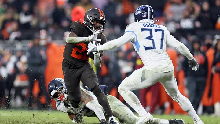 Dec 7, 2025; Cleveland, Ohio, USA; Cleveland Browns running back Dylan Sampson (22) runs the ball for a first down against Tennessee Titans linebacker Cedric Gray (33) and safety Amani Hooker (37) during the fourth quarter at Huntington Bank Field. Mandatory Credit: Scott Galvin-Imagn Images

