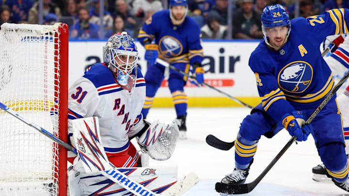 Dec 11, 2024; Buffalo, New York, USA;  New York Rangers goaltender Igor Shesterkin (31) and Buffalo Sabres center Dylan Cozens (24) look for the puck during the second period at KeyBank Center. Mandatory Credit: Timothy T. Ludwig-Imagn Images