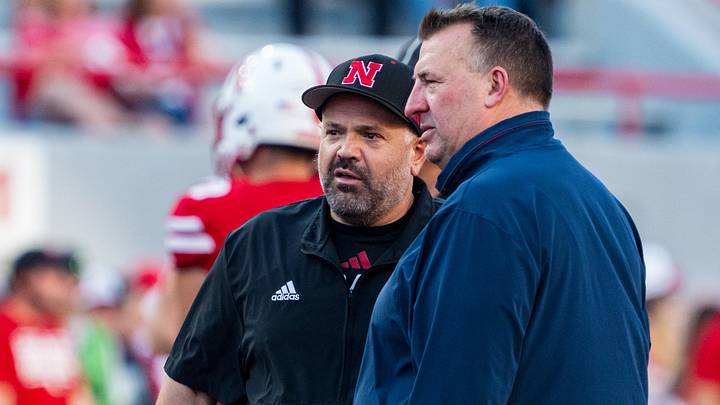 Matt Rhule and Illinois Fighting Illini head coach Bret Bielema talk before a game at Memorial Stadium.