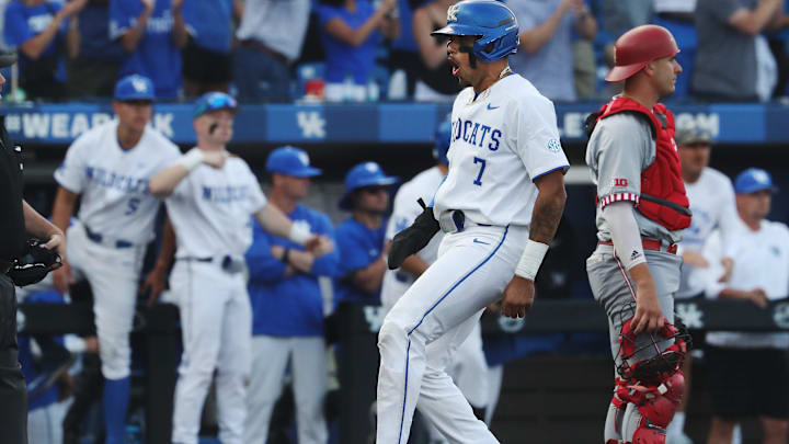 UK's Devin Burkes (7) celebrated as he crossed home plate after he was knocked in on a double by