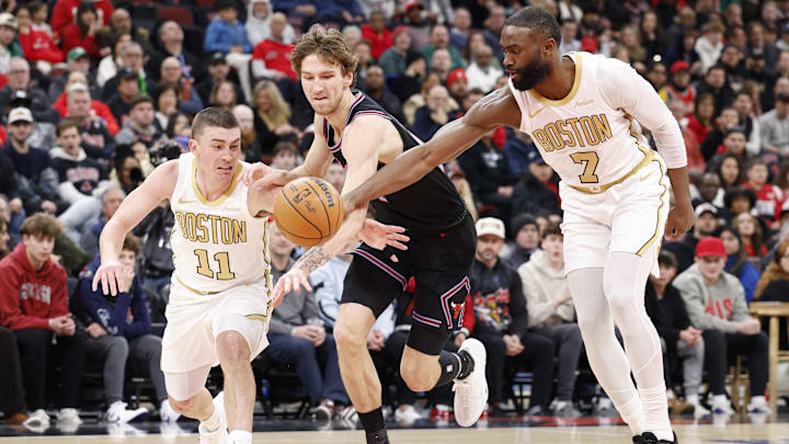 Jan 24, 2026; Chicago, Illinois, USA; Boston Celtics guard Payton Pritchard (11) and guard Jaylen Brown (7) defend against Chicago Bulls forward Matas Buzelis (14) during the first half at United Center. Mandatory Credit: Kamil Krzaczynski-Imagn Images