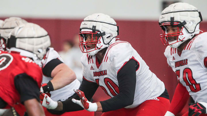 The Louisville offensive and defensive line during practice The Louisville offensive and defensive line during practice