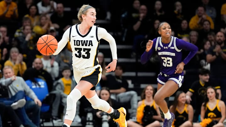 Iowa guard Lucy Olsen (33) brings the ball up court against the Northwestern Wildcats Tuesday, Jan. 28, 2025 at Carver-Hawkeye Arena in Iowa City, Iowa.