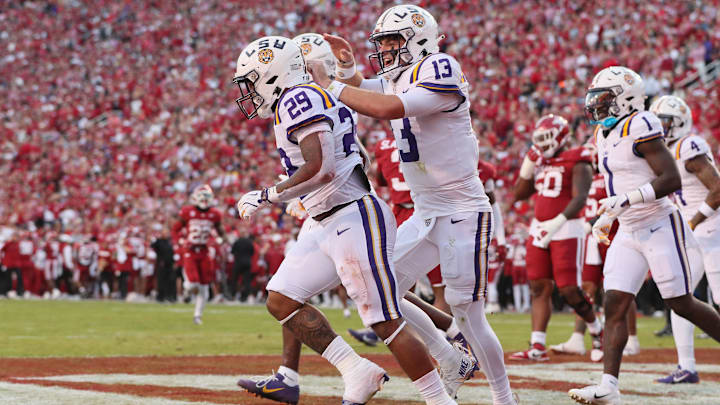 Oct 19, 2024; Fayetteville, Arkansas, USA; LSU Tigers quarterback Garrett Nussmeier (13) celebrates after a rushing touchdown by running back Caden Durham (29) during the first quarter Arkansas Razorbacks at Donald W. Reynolds Razorback Stadium. Mandatory Credit: Nelson Chenault-Imagn Images