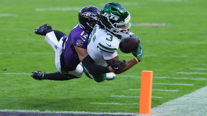 Nov 23, 2025; Baltimore, Maryland, USA;  New York Jets wide reciever John Metchie III (3) scores a touchdown as Baltimore Ravens safety Alohi Gilman (12) defends during the second quarter at M&T Bank Stadium. Mandatory Credit: Mitch Stringer-Imagn Images