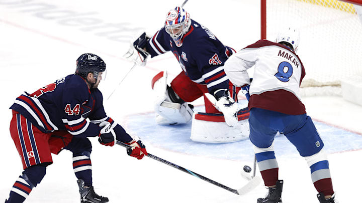 Mar 14, 2026; Winnipeg, Manitoba, CAN; Winnipeg Jets defenseman Josh Morrissey (44) stick checks Colorado Avalanche defenseman Cale Makar (8) in front of Winnipeg Jets goaltender Connor Hellebuyck (37) in the first period at Canada Life Centre. Mandatory Credit: James Carey Lauder-Imagn Images Mar 14, 2026; Winnipeg, Manitoba, CAN; Winnipeg Jets defenseman Josh Morrissey (44) stick checks Colorado Avalanche defenseman Cale Makar (8) in front of Winnipeg Jets goaltender Connor Hellebuyck (37) in the first period at Canada Life Centre. Mandatory Credit: James Carey Lauder-Imagn Images