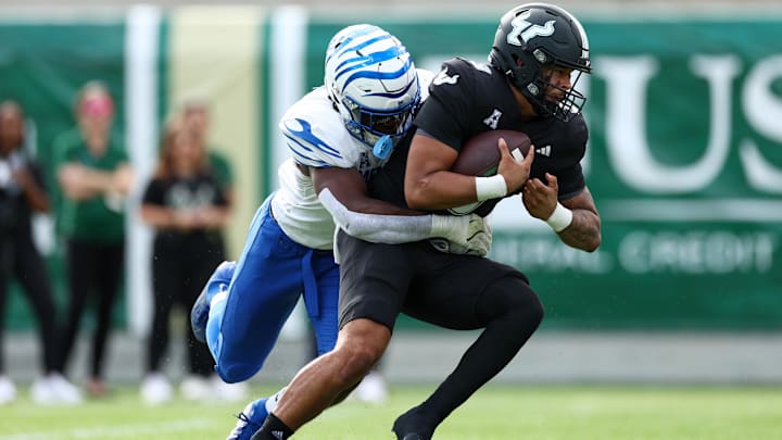 Oct 12, 2024; Orlando, Florida, USA; South Florida Bulls quarterback Bryce Archie (3) is sacked by Memphis Tigers linebacker Chandler Martin (11) in the second quarter at Camping World Stadium. Mandatory Credit: Nathan Ray Seebeck-Imagn Images