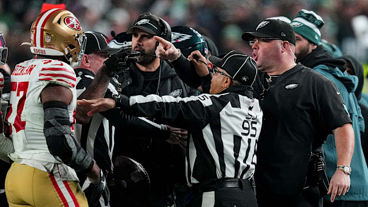 San Francisco 49ers linebacker Dre Greenlaw (L) argues with Philadelphia Eagles security lead Dom DiSandro (R)