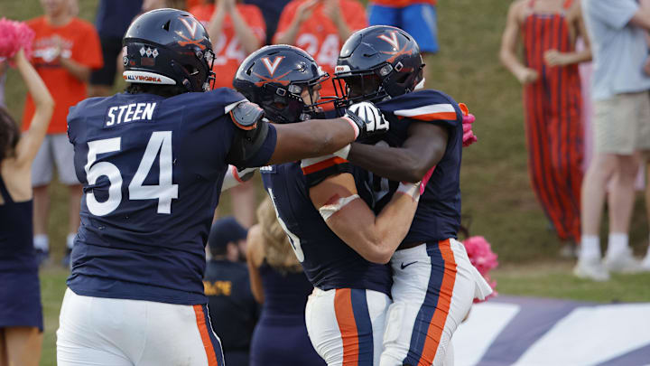 Oct 12, 2024; Charlottesville, Virginia, USA; Virginia Cavaliers running back Xavier Brown (0) celebrates with teammates after scoring a touchdown against the Louisville Cardinals during the second half at Scott Stadium. Mandatory Credit: Amber Searls-Imagn Images