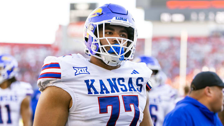 Nov 8, 2025; Tucson, Arizona, USA; Kansas Jayhawks offensive lineman Enrique Cruz Jr. (77) against the Arizona Wildcats at Arizona Stadium. Mandatory Credit: Mark J. Rebilas-Imagn Images