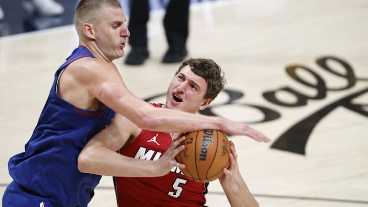 Jun 1, 2023; Denver, CO, USA; Denver Nuggets center Nikola Jokic (15) knocks the ball away from Miami Heat forward Nikola Jovic (5) during the fourth quarter in game one of the 2023 NBA Finals at Ball Arena. Mandatory Credit: Isaiah J. Downing-Imagn Images