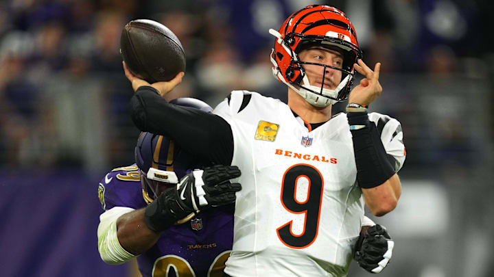 Nov 7, 2024; Baltimore, Maryland, USA; Cincinnati Bengals quarterback Joe Burrow (9) is pressured by Baltimore Ravens linebacker Odafe Oweh (99) during the first quarter at M&T Bank Stadium. Mandatory Credit: Mitch Stringer-Imagn Images