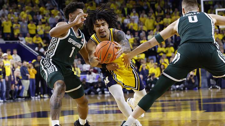 Mar 8, 2026; Ann Arbor, Michigan, USA;  Michigan Wolverines guard Elliot Cadeau (3) dribbles defended by Michigan State Spartans guard Jeremy Fears Jr. (1) and forward Jaxon Kohler (0) in the first half at Crisler Center. Mandatory Credit: Rick Osentoski-Imagn Images