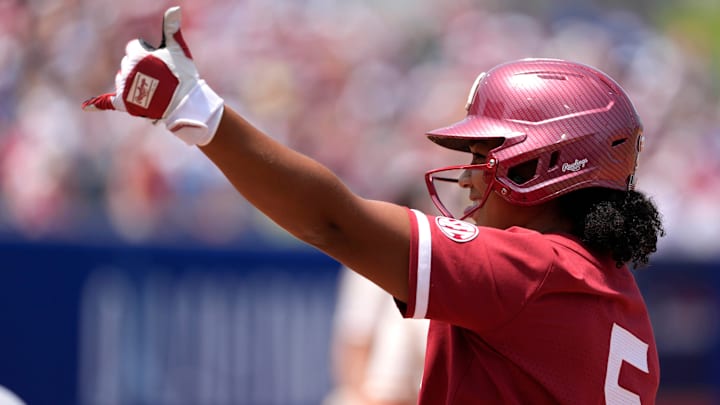Oklahoma slugger Ella Parker celebrates a base hit at the WCWS. Oklahoma slugger Ella Parker celebrates a base hit at the WCWS.